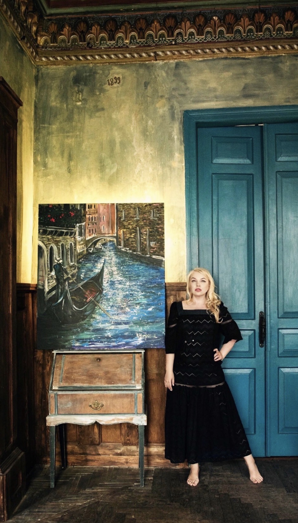 Ukrainian artist Marina Stognieva with the painting Venetian Silence in her art studio